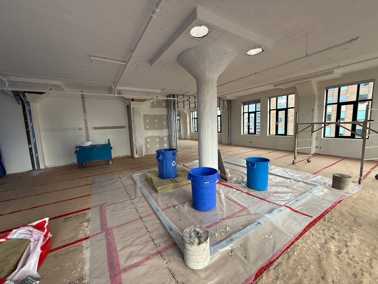 debris contained in buckets for clean concrete removal upper floor